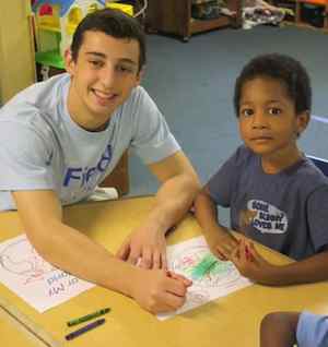 Kid colors with volunteers-ColorMyWorld-photo
